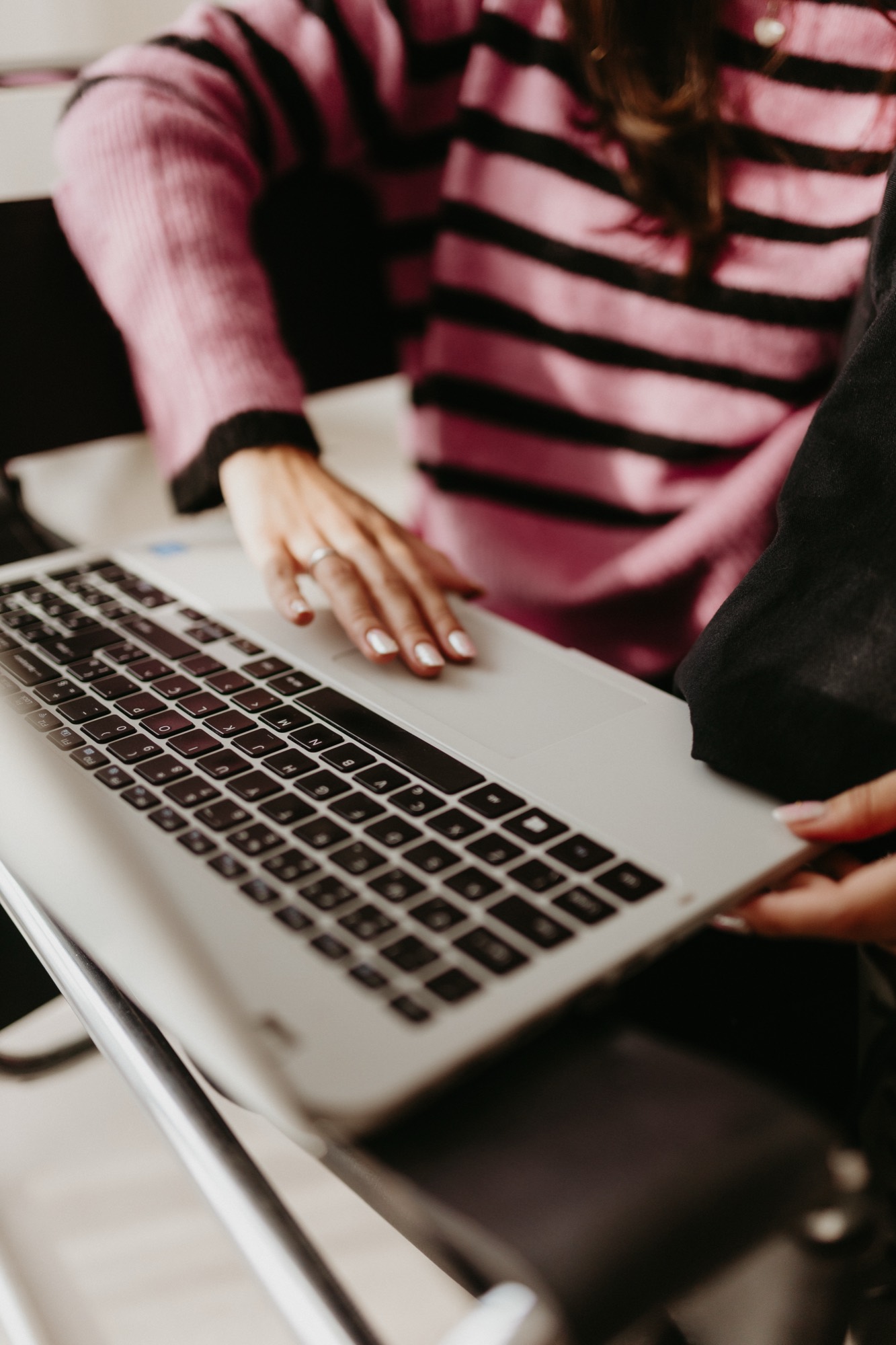 Two founders of Lumar Content Studio working together on a laptop